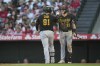 Pittsburgh Pirates designated hitter Ji Man Choi (91) celebrates with Henry Davis (32) after hitting a home run during the fourth inning of a baseball game against the Los Angeles Angels in Anaheim, Calif., Friday, July 21, 2023. (AP Photo/Ashley Landis)