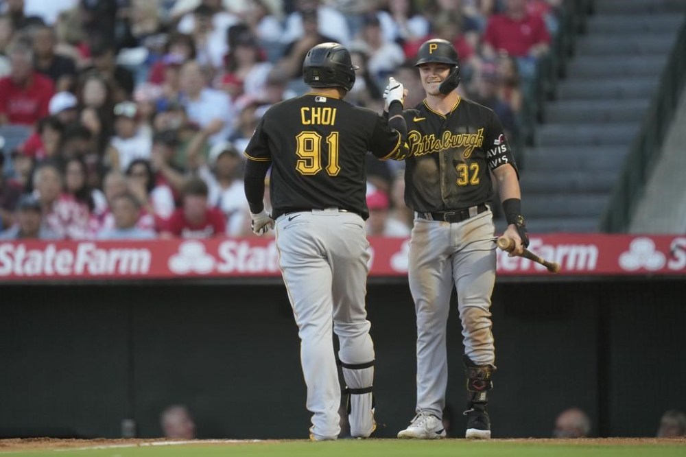 Pittsburgh Pirates designated hitter Ji Man Choi (91) celebrates with Henry Davis (32) after hitting a home run during the fourth inning of a baseball game against the Los Angeles Angels in Anaheim, Calif., Friday, July 21, 2023. (AP Photo/Ashley Landis)
