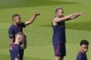 PSG's Neymar, right, and Kylian Mbappe gesture during a training session at the new Paris Saint-Germain training center Thursday, July 20, 2023 in Poissy, west of Paris. (AP Photo/Christophe Ena)