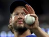 Los Angeles Dodgers pitcher Clayton Kershaw waves at fans from the dugout during a baseball game against the Texas Rangers, Friday, July 21, 2023, in Arlington, Texas. (AP Photo/Richard W. Rodriguez)