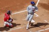 New York Mets' Pete Alonso (20) scores in front of Boston Red Sox's Connor Wong on a single by Brett Baty during the sixth inning in the continuation of a suspended baseball game, Saturday, July 22, 2023, in Boston. The game was suspended the night before due to heavy rain. (AP Photo/Michael Dwyer)