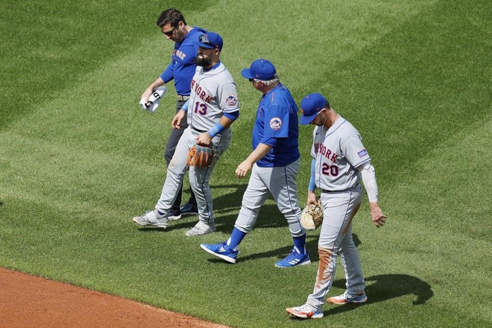New York Mets' Luis Guillorme (13) limps off the field after being injured while fielding a single by Boston Red Sox's Rafael Devers during the sixth inning in the continuation of a suspended baseball game, Saturday, July 22, 2023, in Boston. The game was suspended the night before due to heavy rain. (AP Photo/Michael Dwyer)