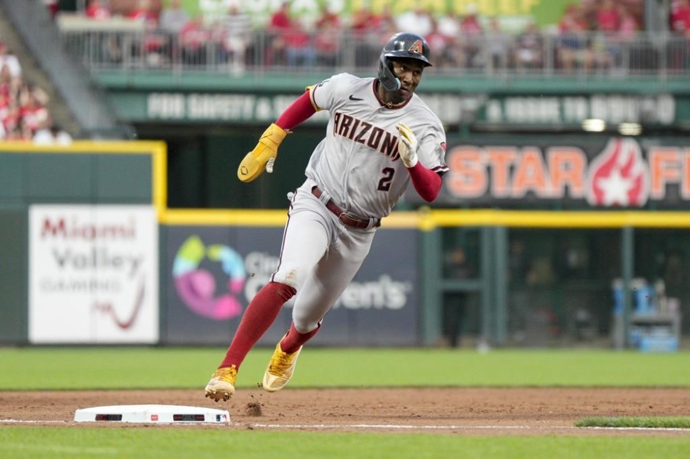 Arizona Diamondbacks' Geraldo Perdomo rounds third base on his way to scoring on a triple hit by Ketel Marte during the fifth inning of a baseball game against the Cincinnati Reds, Friday, July 21, 2023, in Cincinnati. (AP Photo/Jeff Dean)