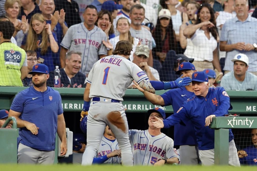 New York Mets' Jeff McNeil (1) celebrates after hitting a two-run single and then scoring on a throwing error by Boston Red Sox's Jorge Alfaro during the fourth inning of a baseball game, Saturday, July 22, 2023, in Boston. (AP Photo/Michael Dwyer)
