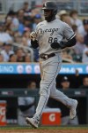 Chicago White Sox's Luis Robert Jr. scores on a single by Yasmani Grandal against the Minnesota Twins in the third inning of a baseball game Saturday, July 22, 2023, in Minneapolis. (AP Photo/Bruce Kluckhohn)