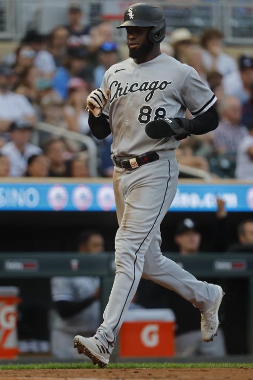 Chicago White Sox's Luis Robert Jr. scores on a single by Yasmani Grandal against the Minnesota Twins in the third inning of a baseball game Saturday, July 22, 2023, in Minneapolis. (AP Photo/Bruce Kluckhohn)