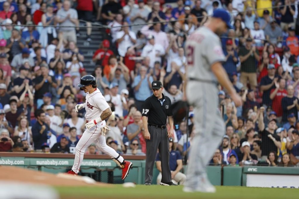 Boston Red Sox's Jarren Duran, left, rounds third base after hitting a solo home run off New York Mets' Max Scherzer, right, during the first inning of a baseball game, Saturday, July 22, 2023, in Boston. (AP Photo/Michael Dwyer)