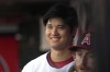 Los Angeles Angels' Shohei Ohtani smiles as he stands in the dugout prior to a baseball game against the Pittsburgh Pirates Saturday, July 22, 2023, in Anaheim, Calif. (AP Photo/Mark J. Terrill)