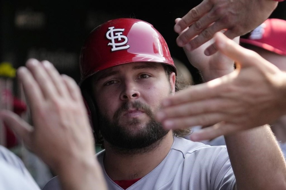 St. Louis Cardinals' Alec Burleson celebrates with teammates after scoring on a one-run single by Dylan Carlson during the sixth inning of a baseball game against the Chicago Cubs in Chicago, Sunday, July 23, 2023. (AP Photo/Nam Y. Huh)