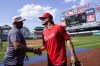 Washington Nationals manager Dave Martinez, left, greets Dylan Crews, the second overall pick in the Major League Baseball draft, during batting practice before a game against the San Francisco Giants at Nationals Park, Saturday, July 22, 2023, in Washington. (AP Photo/Alex Brandon)