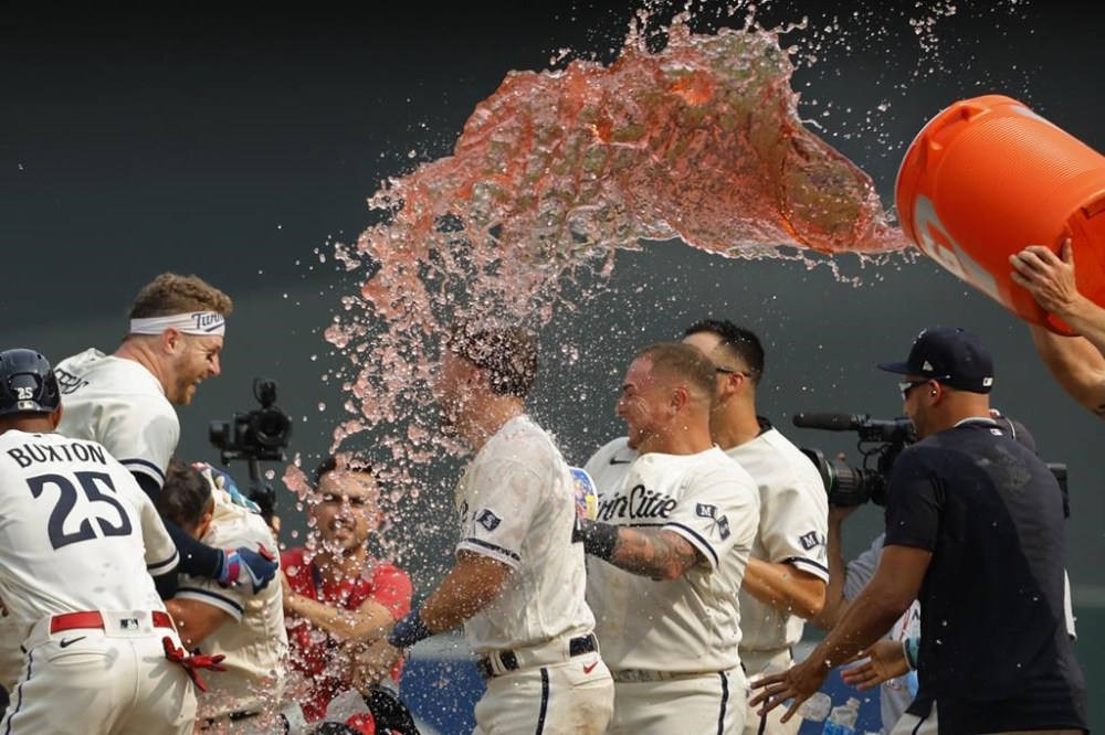 Minnesota Twins celebrate after Ryan Jeffers, second from left, hit an RBI single against the Chicago White Sox in the 12th inning of a baseball game Sunday, July 23, 2023, in Minneapolis. (AP Photo/Bruce Kluckhohn)