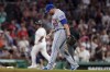 New York Mets' Dominic Leone (50) steps on the mound as Boston Red Sox's Rafael Devers, left, runs the bases toward home after hitting a home run in the seventh inning of a baseball game, Sunday, July 23, 2023, in Boston. (AP Photo/Steven Senne)