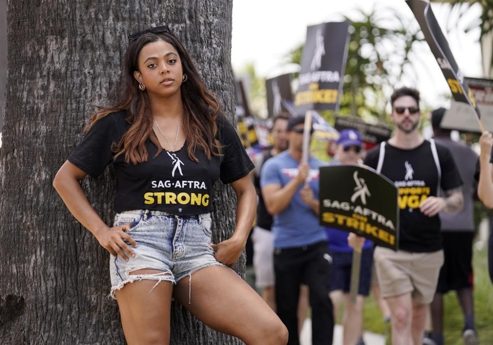 Actor Amari Dejoie poses for a portrait near SAG-AFTRA and WGA picket lines outside Netflix, Friday, July 21, 2023, in Los Angeles. (AP Photo/Chris Pizzello)
