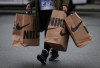 When the cost of nearly everything is on the rise, it can be difficult for young Canadians to imagine putting money aside for wants rather than solely for needs. A person carries shopping bags full of purchases as they leave the McArthurGlen Designer Outlet on Boxing Day, in Richmond, B.C., Monday, Dec. 26, 2022. THE CANADIAN PRESS/Darryl Dyck