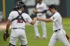 Cleveland Guardians starting pitcher Logan Allen, right, bumps fists with catcher David Fry, left, as he walks off the field after the first half of the first inning of a baseball game against the Kansas City Royals, Monday, July 24, 2023, in Cleveland. (AP Photo/Sue Ogrocki)