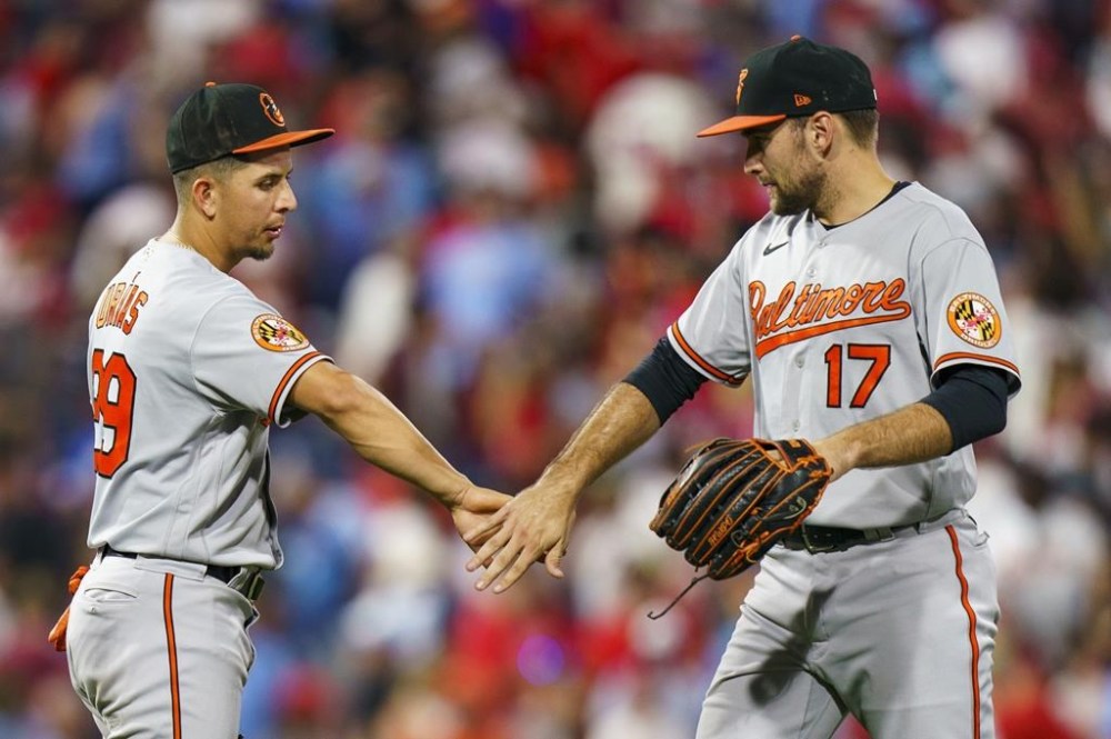 Baltimore Orioles' Colton Cowser, right, celebrates after a win with Ramon Urias after a baseball game against the Philadelphia Phillies, Monday, July 24, 2023, in Philadelphia. (AP Photo/Chris Szagola)