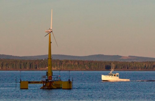 FILE - A lobster boat passes the country's first floating wind turbine off the coast of Castine, Maine, Sept. 20, 2013. Maine is poised to launch an offshore wind program to meet clean energy goals with a goal of producing enough power for about 900,000 homes from floating wind turbines in the Gulf of Maine. (AP Photo/Robert F. Bukaty)