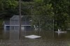 A man paddles a kayak through a flooded baseball diamond following a major rain event in Halifax on Saturday, July 22, 2023. Police are expected to provide an update today on the search for two young children who were swept away in weekend flooding in Nova Scotia. THE CANADIAN PRESS/Darren Calabrese