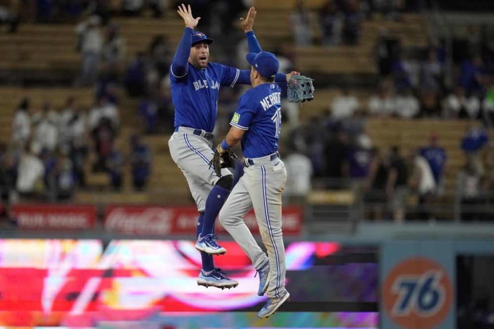 The Toronto Blue Jays announced their spring training schedule for 2024 with 32 games against nine different teams. Jays right fielder George Springer, left, and second baseman Whit Merrifield celebrate after a 6-3 win over the Los Angeles Dodgers in a baseball game in Los Angeles, Monday, July 24, 2023. THE CANADIAN PRESS/AP-Marcio Jose Sanchez