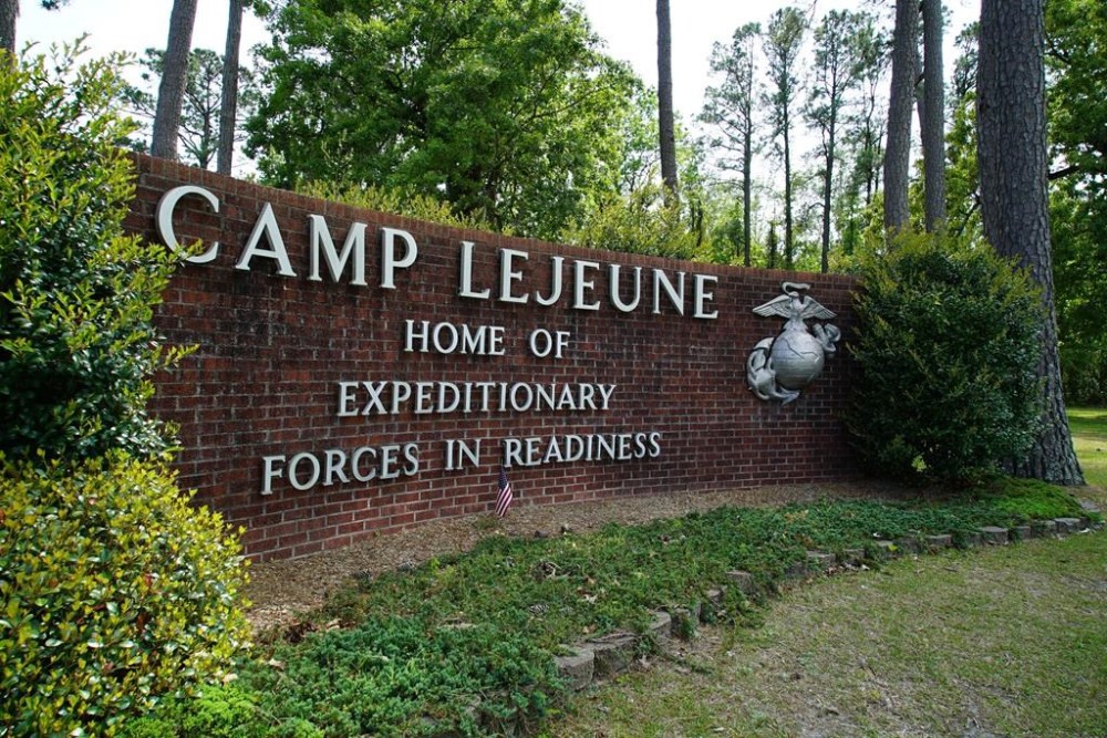 FILE - Signage stands on the main gate to Camp Lejeune Marine Base outside Jacksonville, N.C., Friday, April 29, 2022. Three men who were found dead over the weekend at an eastern North Carolina gas station have been identified as Marine lance corporals stationed nearby at Camp Lejeune, the U.S. Marine Corps said Tuesday, July 25, 2023. (AP Photo/Allen G. Breed, File)
