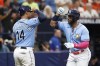 Tampa Bay Rays' Yandy Diaz, right, celebrates with teammate Christian Bethancourt after hitting a two-run home run against the Baltimore Orioles during the fifth inning of a baseball game, Sunday, July 23, 2023, in St. Petersburg, Fla. (AP Photo/Scott Audette)