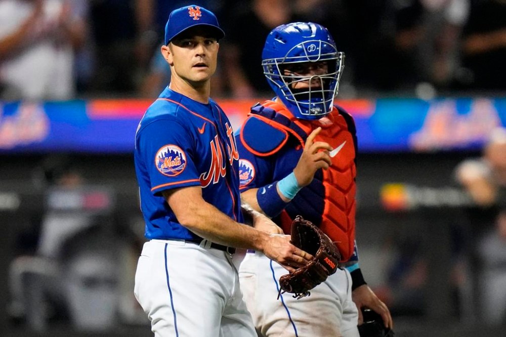 New York Mets relief pitcher David Robertson, left, talks to catcher Francisco Alvarez after a baseball game against the Chicago White Sox Tuesday, July 18, 2023, in New York. The Mets won 11-10. (AP Photo/Frank Franklin II)