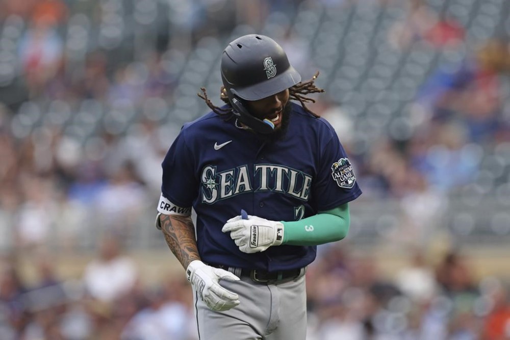 Seattle Mariners' J.P. Crawford reacts after hitting a ground ball to Minnesota Twins first baseman Alex Kirilloff for an out during the first inning of a baseball game, Tuesday, July 25, 2023, in Minneapolis. (AP Photo/Stacy Bengs)