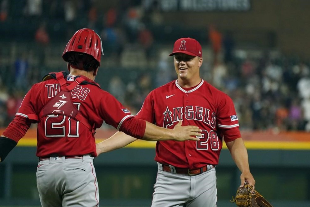 Los Angeles Angels relief pitcher Aaron Loup (28) shakes hands with catcher Matt Thaiss after the 10th inning of a baseball game against the Detroit Tigers, Tuesday, July 25, 2023, in Detroit. (AP Photo/Carlos Osorio)