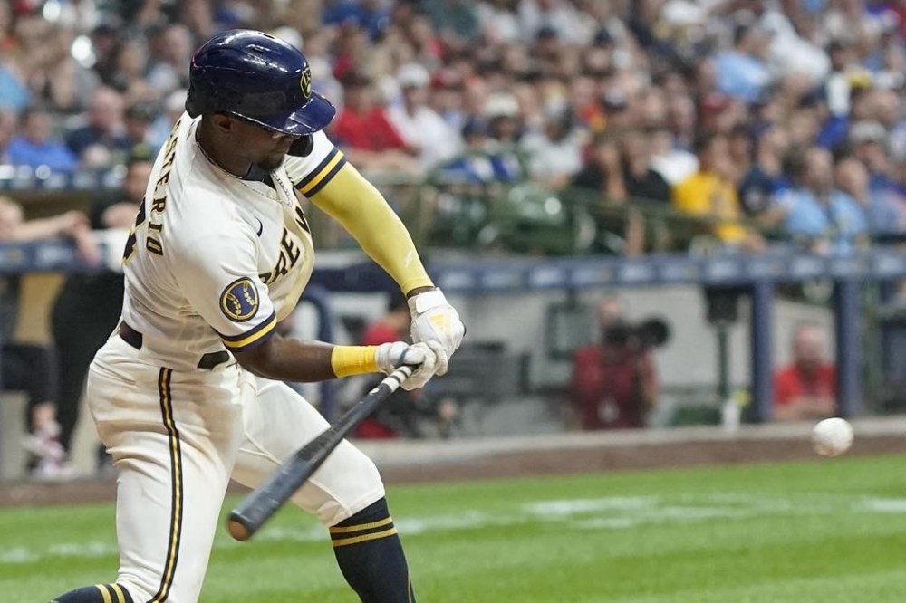 Milwaukee Brewers' Andruw Monasterio hits a single during the fourth inning of a baseball game against the Cincinnati Reds Tuesday, July 25, 2023, in Milwaukee. (AP Photo/Morry Gash)