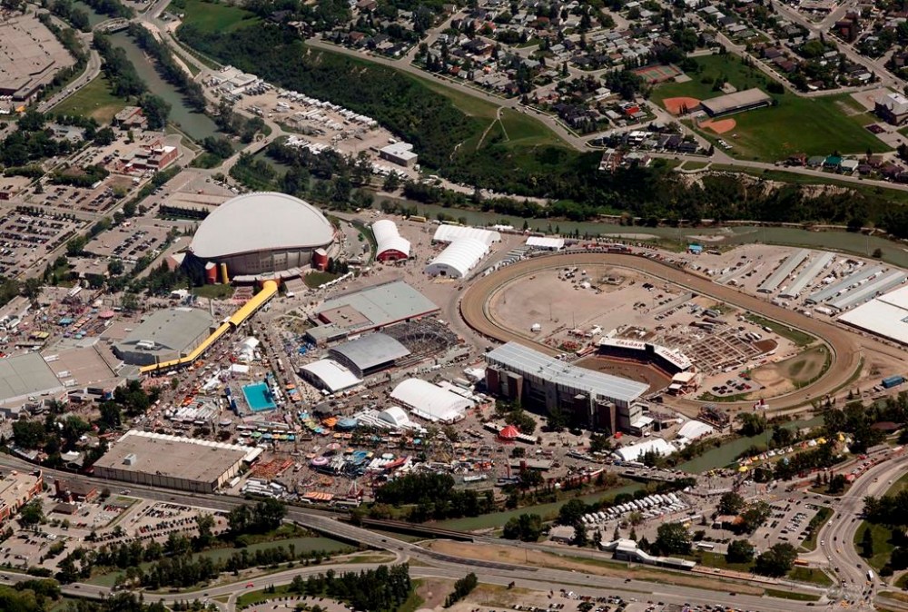 The Calgary Stampede grounds and the Saddledome are seen from the air in Calgary, on Thursday, July 11, 2013. A partial settlement has been reached in a class-action lawsuit against the Calgary Stampede alleging the organization allowed a performance school staffer to sexually abuse young boys.THE CANADIAN PRESS/Jeff McIntosh