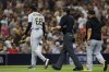 Pittsburgh Pirates relief pitcher Angel Perdomo (68) is escorted off the field by umpire John Tumpane, center, after hitting San Diego Padres' Manny Machado with a pitch during the seventh inning of a baseball game Tuesday, July 25, 2023, in San Diego. (AP Photo/Derrick Tuskan)