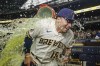 Milwaukee Brewers' Willy Adames douces Tyrone Taylor after a baseball game against the Cincinnati Reds Wednesday, July 26, 2023, in Milwaukee. The Brewers won 3-0. (AP Photo/Morry Gash)