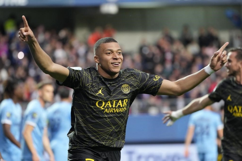 FILE - PSG's Kylian Mbappe celebrates after scoring his side's opening goal during the French League One soccer match between Troyes and Paris Saint Germain, at the Stade de l'Aube, in Troyes, France, Sunday, May 7, 2023. Saudi Arabian soccer team Al-Hilal has made a record $332 million bid for France striker Kylian Mbappe. Paris Saint-Germain has confirmed the offer and says it has given Al-Hilal permission to open negotiations directly with Mbappe. (AP Photo/Lewis Joly, File)