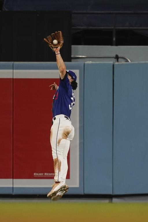 Los Angeles Dodgers center fielder James Outman (33) catches a line out from Toronto Blue Jays' Vladimir Guerrero Jr. during the seventh inning of a baseball game against the Toronto Blue Jays, Tuesday, July 25, 2023, in Los Angeles. (AP Photo/Ryan Sun)