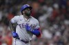 Texas Rangers' Adolis Garcia jogs around the bases after hitting a grand slam during the fifth inning of a baseball game against the Houston Astros, Wednesday, July 26, 2023, in Houston. (AP Photo/Kevin M. Cox)