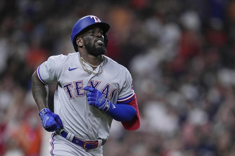 Texas Rangers' Adolis Garcia jogs around the bases after hitting a grand slam during the fifth inning of a baseball game against the Houston Astros, Wednesday, July 26, 2023, in Houston. (AP Photo/Kevin M. Cox)