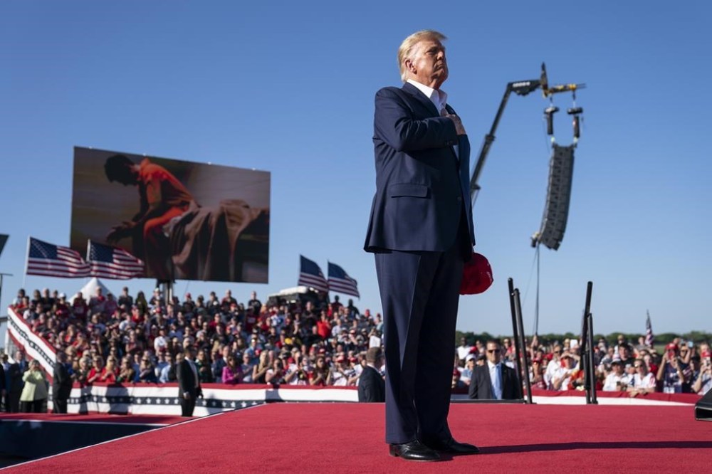 FILE - Former President Donald Trump stands while a song,
