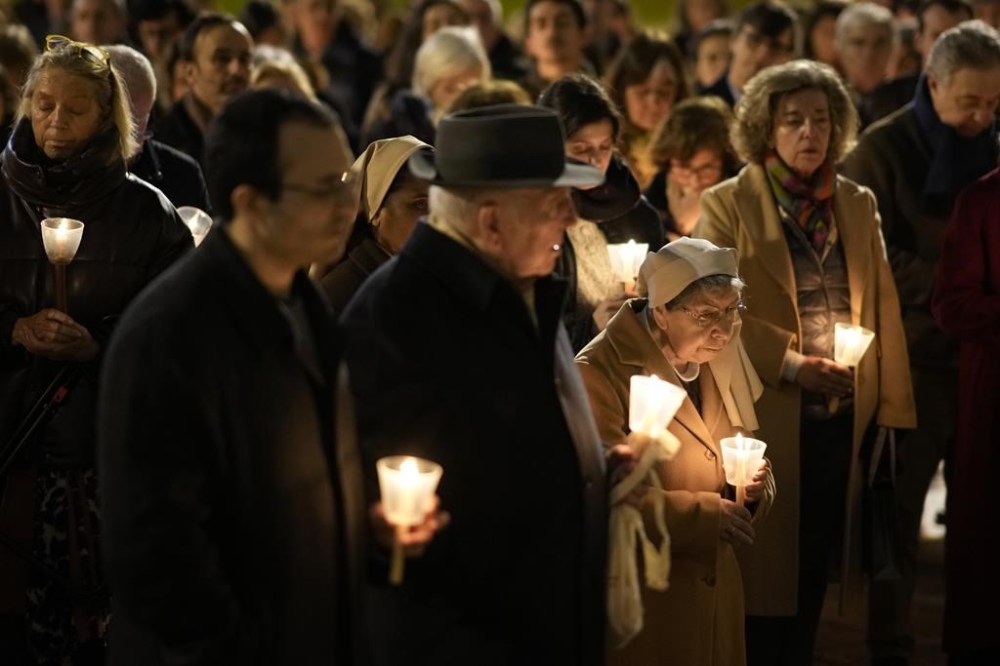 FILE - Faithful hold a vigil of silence and prayer for the victims of sexual abuse by the Catholic Church, outside the 16th century Jeronimos Monastery in Lisbon, Wednesday, Feb. 22, 2023. Pope Francis is going on a five-day visit next week to Portugal, where a scandal that erupted earlier this year over Catholic Church sex abuse is still simmering. (AP Photo/Armando Franca, File)
