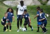 Vancouver Whitecaps midfielder Alphonso Davies, centre left, plays soccer with kids at the Musqueam First Nation, in Vancouver, on Monday July 9, 2018. Soccer is the most popular sport for young Canadians to play, according to a recent study. THE CANADIAN PRESS/Darryl Dyck