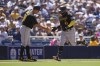 Pittsburgh Pirates' Carlos Santana (41) celebrates with third base coach Mike Rabelo after hitting a home run during the ninth inning of a baseball game against the San Diego Padres, Wednesday, July 26, 2023, in San Diego. (AP Photo/Gregory Bull)
