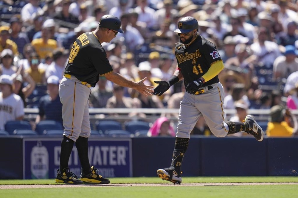 Pittsburgh Pirates' Carlos Santana (41) celebrates with third base coach Mike Rabelo after hitting a home run during the ninth inning of a baseball game against the San Diego Padres, Wednesday, July 26, 2023, in San Diego. (AP Photo/Gregory Bull)