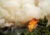 Flames from the Donnie Creek wildfire burn along a ridge top north of Fort St. John, B.C. on Sunday, July 2, 2023. THE CANADIAN PRESS/AP/Noah Berger