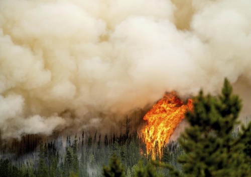 Flames from the Donnie Creek wildfire burn along a ridge top north of Fort St. John, B.C. on Sunday, July 2, 2023. THE CANADIAN PRESS/AP/Noah Berger