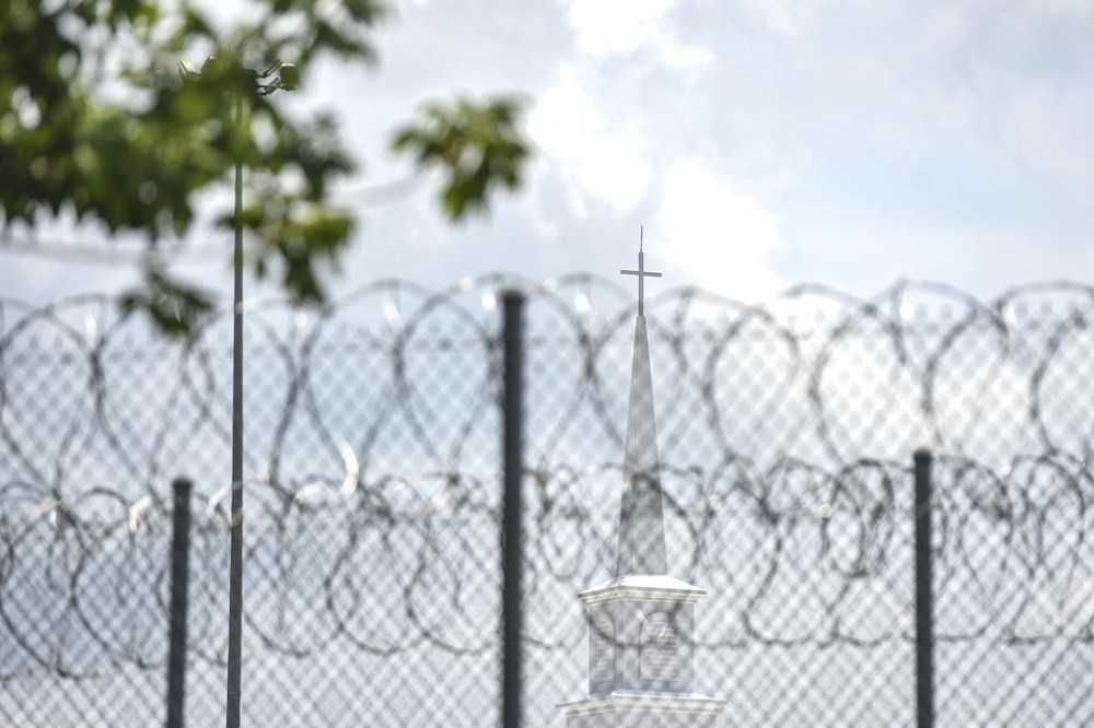 FILE - A church steeple peaks over the barbed-wire fence following the dedication of the newly constructed chapel at the Mississippi Correctional Institute for Women (MCIW) at Central Mississippi Correctional Facility in Pearl, Miss., June 15, 2023. A former Mississippi prison guard on Thursday, July 27, pleaded guilty to deprivation of an inmate's rights by using excessive force when she was a corrections officer at the Central Mississippi Correctional Facility, the U.S. Justice Department said. (Hannah Mattix/The Clarion-Ledger via AP, File)