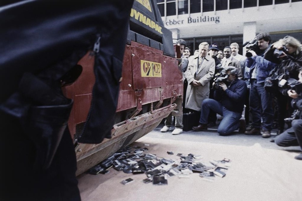 FILE - Cassettes and CDs by Irish singer Sinéad O'Connor are flattened by a pavement roller on New York City's Avenue of the Americas, Oct. 21, 1992. The recordings, donated by unhappy record fans, were collected by the National Ethnic Coalition of Organizations, which planned to deliver the crushed remains to the singer. In 1992, O’Connor destroyed a photo of Pope John Paul II on U.S. national television. The pushback was swift, turning the late Irish singer-songwriter’s protest of sex abuse in the Catholic Church into a career-altering flashpoint. (AP Photo/Bebeto Matthews, File)