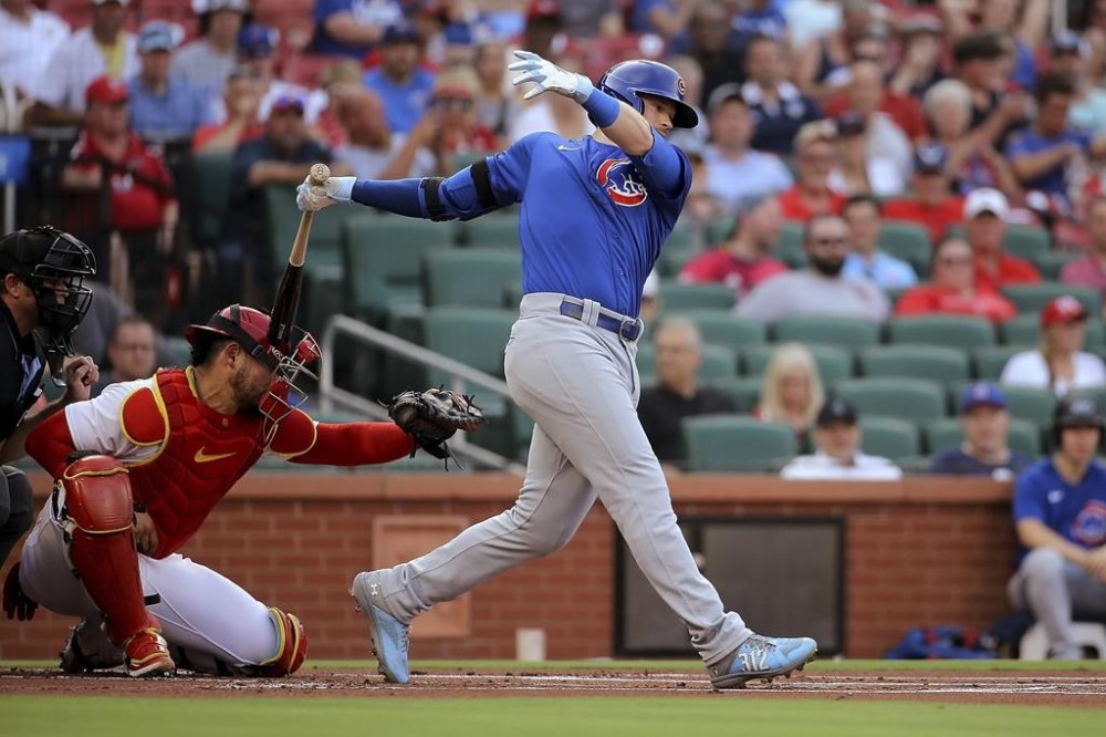 St. Louis Cardinals catcher Willson Contreras is hit the bat as Chicago Cubs' Ian Happ follows through on a swing during the first inning of a baseball game Thursday, July 27, 2023, in St. Louis. (AP Photo/Scott Kane)