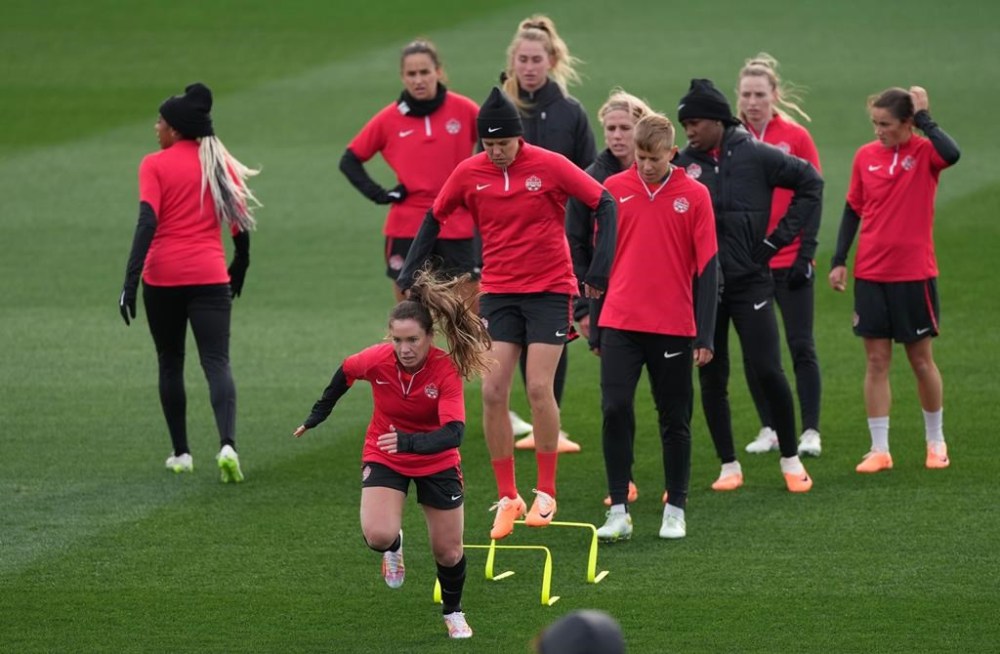 Allysha Chapman, Christine Sinclair and Quinn (front, left to right) take part in a drill during a training session ahead of the FIFA Women's World Cup in Melbourne, Australia, Thursday, July 20, 2023. A day after making headlines for lack of media access, Canada Soccer scheduled a player availability for Saturday. THE CANADIAN PRESS/Scott Barbour