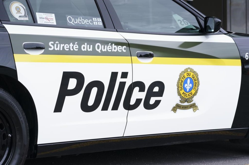 A Sûreté du Québec police car is seen in Montreal on Wednesday, July 22, 2020. Three people are dead and three others were injured in a two-vehicle crash Thursday evening in Quebec's Saguenay-Lac-St-Jean region. THE CANADIAN PRESS/Paul Chiasson
