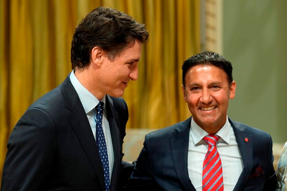 Minister of Justice and Attorney General of Canada Arif Virani poses for a photo with Prime Minister Justin Trudeau during a cabinet swearing-in ceremony at Rideau Hall in Ottawa, Wednesday, July 26, 2023. Canada's new justice minister says he plans to tell his staff and department to move