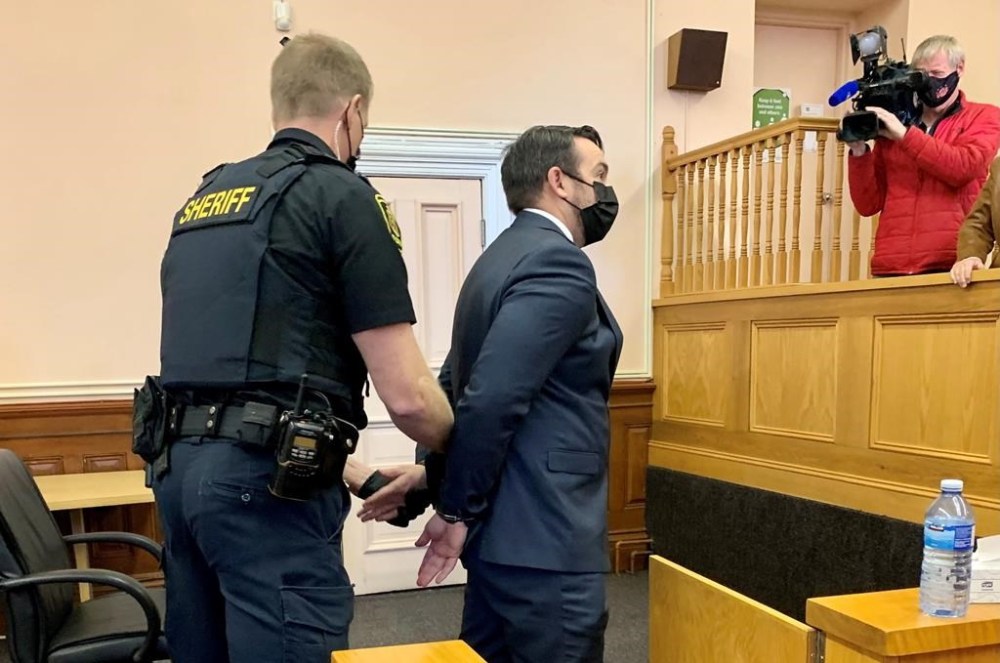 Const. Carl Douglas Snelgrove, centre, of the Royal Newfoundland Constabulary, is shown in court in St. John's on Friday Nov. 12, 2021. THE CANADIAN PRESS/Sarah Smellie